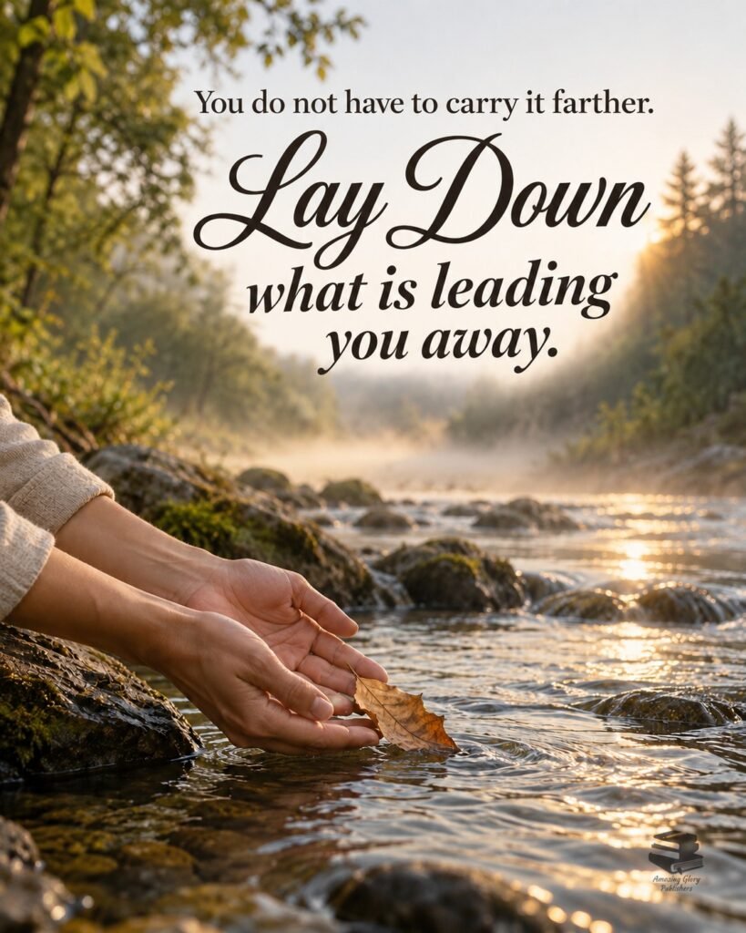 Hands releasing a dry leaf into a clear forest stream at sunrise, with the words: You do not have to carry it farther. Lay down what is leading you away.